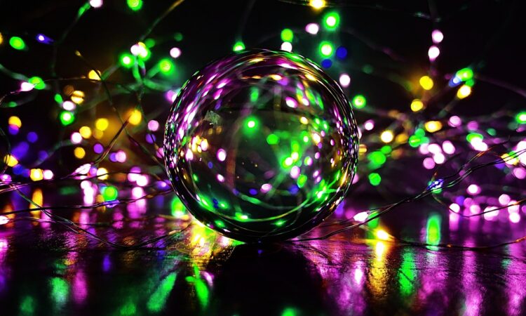 a glass ball with colorful lights around it