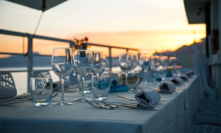 a table with wine glasses and cutlery