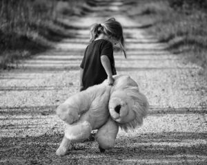 a girl holding a large stuffed animal