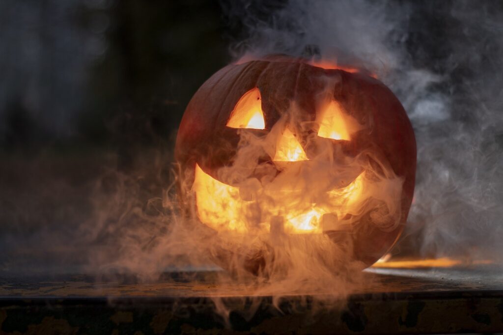 a carved pumpkin with smoke