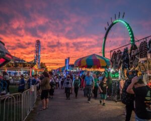 a crowd of people walking in a fair