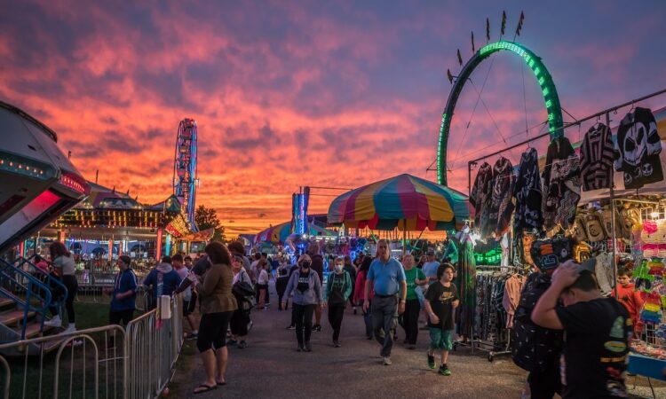 a crowd of people walking in a fair