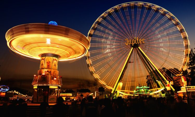 a ferris wheel and a carousel at night martinimarkt neuruppin 2024